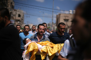 A Palestinian relative carries the body of four-year-old Qassim Elwan